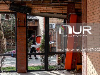 A man carries a piece of rubble near the Delta hotel and restaurant damaged by a Russian drone attack in Vylkove, Odesa region, southern Ukr...