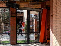 A man carries a piece of rubble near the Delta hotel and restaurant damaged by a Russian drone attack in Vylkove, Odesa region, southern Ukr...