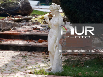 A statue stands near the Delta hotel and restaurant, which is damaged by a Russian drone attack in Vylkove, Ukraine, on October 11, 2024. (