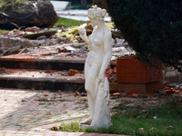 A statue stands near the Delta hotel and restaurant, which is damaged by a Russian drone attack in Vylkove, Ukraine, on October 11, 2024. (