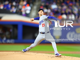 Los Angeles Dodgers starting pitcher Walker Buehler #21 throws during the first inning in Game 3 of the baseball NL Championship Series agai...