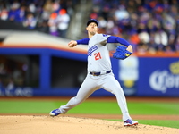 Los Angeles Dodgers starting pitcher Walker Buehler #21 throws during the first inning in Game 3 of the baseball NL Championship Series agai...