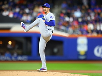 Los Angeles Dodgers starting pitcher Walker Buehler #21 throws during the first inning in Game 3 of the baseball NL Championship Series agai...