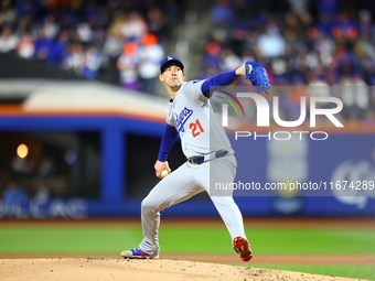 Los Angeles Dodgers starting pitcher Walker Buehler #21 throws during the first inning in Game 3 of the baseball NL Championship Series agai...