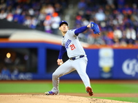 Los Angeles Dodgers starting pitcher Walker Buehler #21 throws during the first inning in Game 3 of the baseball NL Championship Series agai...