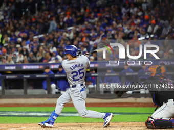 Tommy Edman #25 of the Los Angeles Dodgers breaks his bat during the fourth inning in Game 3 of the baseball NL Championship Series against...