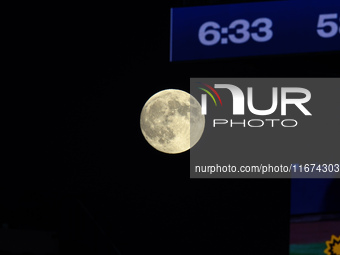 A full moon rises before Game 3 of the baseball NL Championship Series between the Los Angeles Dodgers and the New York Mets at Citi Field i...