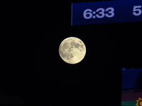 A full moon rises before Game 3 of the baseball NL Championship Series between the Los Angeles Dodgers and the New York Mets at Citi Field i...