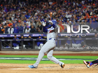 Teoscar Hernandez #37 of the Los Angeles Dodgers breaks his bat during the third inning in Game 3 of the baseball NL Championship Series aga...