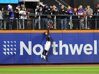 Two fans catch Los Angeles Dodgers Enrique Hernandez #8 home run as New York Mets outfielder Brandon Nimmo #9 leaps in vain during the sixth...