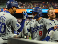 Enrique Hernandez #8 of the Los Angeles Dodgers celebrates with teammates after homering during the sixth inning in Game 3 of the baseball N...