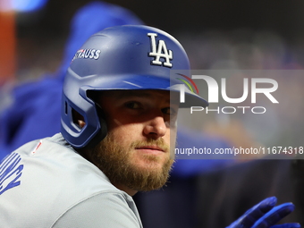 Max Muncy #13 of the Los Angeles Dodgers stands in the hole during the eighth inning in Game 3 of the baseball NL Championship Series agains...