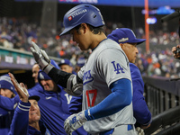 Los Angeles Dodgers' Shohei Ohtani #17 is congratulated by teammates after hitting a home run in the eighth inning in Game 3 of the baseball...