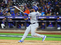 Max Muncy #13 of the Los Angeles Dodgers hits a home run during the ninth inning in Game 3 of the baseball NL Championship Series against th...