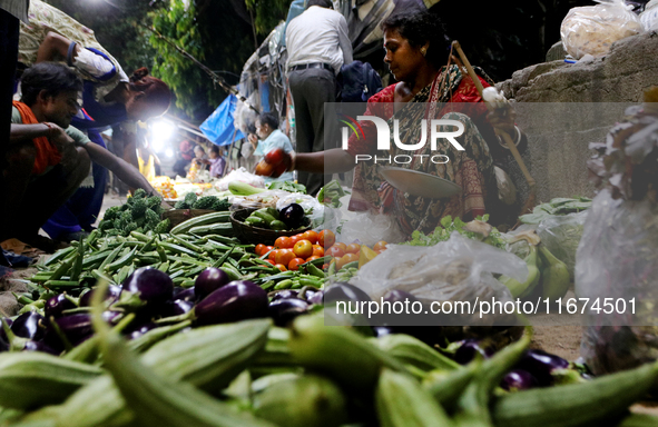 An Indian seller waits for a customer at the vegetable daily market in Kolkata, India, on October 17, 2024. India's retail inflation rises t...