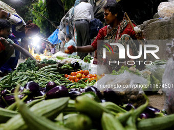 An Indian seller waits for a customer at the vegetable daily market in Kolkata, India, on October 17, 2024. India's retail inflation rises t...