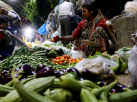 An Indian seller waits for a customer at the vegetable daily market in Kolkata, India, on October 17, 2024. India's retail inflation rises t...