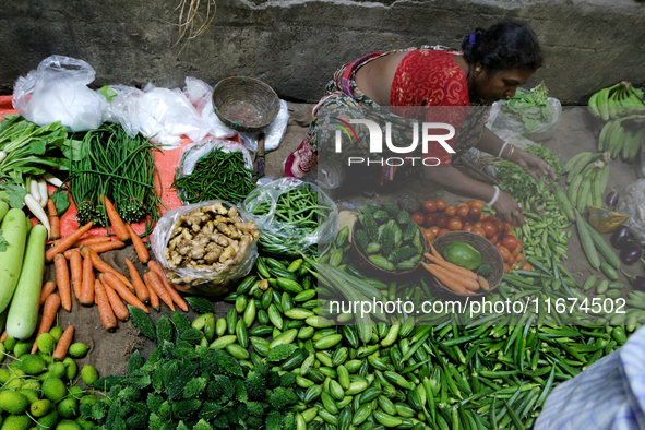 An Indian seller waits for a customer at the vegetable daily market in Kolkata, India, on October 17, 2024. India's retail inflation rises t...