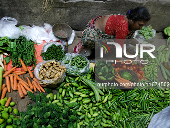 An Indian seller waits for a customer at the vegetable daily market in Kolkata, India, on October 17, 2024. India's retail inflation rises t...