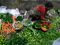 An Indian seller waits for a customer at the vegetable daily market in Kolkata, India, on October 17, 2024. India's retail inflation rises t...