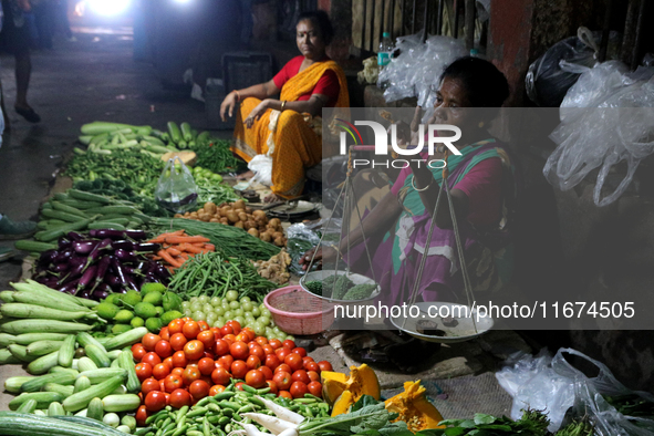 An Indian seller waits for a customer at the vegetable daily market in Kolkata, India, on October 17, 2024. India's retail inflation rises t...