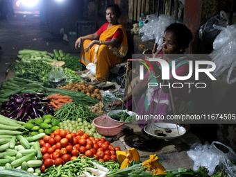 An Indian seller waits for a customer at the vegetable daily market in Kolkata, India, on October 17, 2024. India's retail inflation rises t...