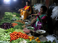 An Indian seller waits for a customer at the vegetable daily market in Kolkata, India, on October 17, 2024. India's retail inflation rises t...