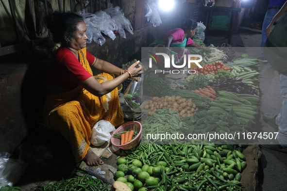 An Indian seller waits for a customer at the vegetable daily market in Kolkata, India, on October 17, 2024. India's retail inflation rises t...