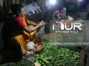 An Indian seller waits for a customer at the vegetable daily market in Kolkata, India, on October 17, 2024. India's retail inflation rises t...