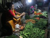 An Indian seller waits for a customer at the vegetable daily market in Kolkata, India, on October 17, 2024. India's retail inflation rises t...