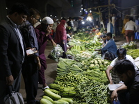 Residents buy vegetables beside a road in Dhaka, Bangladesh, on October 17, 2024. Vegetable prices rise after Bangladesh faces several flood...