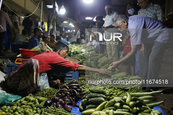 Residents buy vegetables beside a road in Dhaka, Bangladesh, on October 17, 2024. Vegetable prices rise after Bangladesh faces several flood...