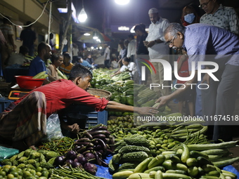 Residents buy vegetables beside a road in Dhaka, Bangladesh, on October 17, 2024. Vegetable prices rise after Bangladesh faces several flood...