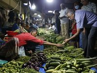 Residents buy vegetables beside a road in Dhaka, Bangladesh, on October 17, 2024. Vegetable prices rise after Bangladesh faces several flood...