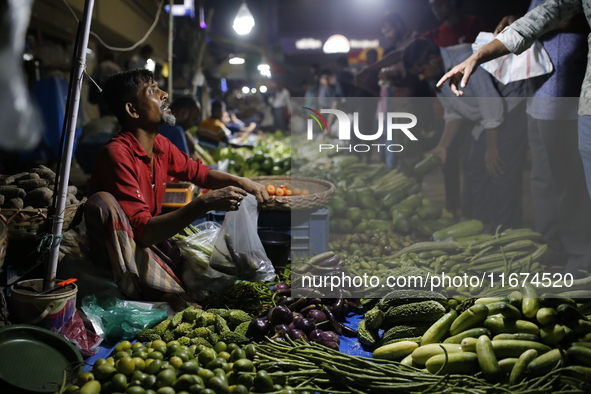 Residents buy vegetables beside a road in Dhaka, Bangladesh, on October 17, 2024. Vegetable prices rise after Bangladesh faces several flood...