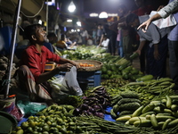 Residents buy vegetables beside a road in Dhaka, Bangladesh, on October 17, 2024. Vegetable prices rise after Bangladesh faces several flood...