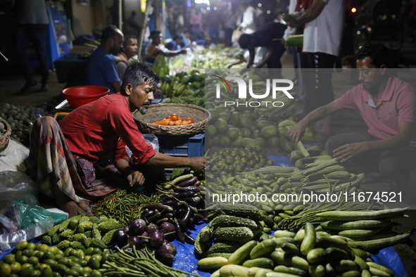 Residents buy vegetables beside a road in Dhaka, Bangladesh, on October 17, 2024. Vegetable prices rise after Bangladesh faces several flood...