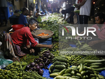 Residents buy vegetables beside a road in Dhaka, Bangladesh, on October 17, 2024. Vegetable prices rise after Bangladesh faces several flood...