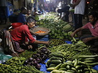 Residents buy vegetables beside a road in Dhaka, Bangladesh, on October 17, 2024. Vegetable prices rise after Bangladesh faces several flood...