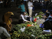 Residents buy vegetables beside a road in Dhaka, Bangladesh, on October 17, 2024. Vegetable prices rise after Bangladesh faces several flood...