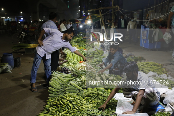 Residents buy vegetables beside a road in Dhaka, Bangladesh, on October 17, 2024. Vegetable prices rise after Bangladesh faces several flood...