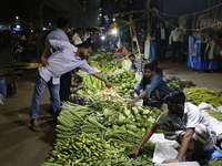 Residents buy vegetables beside a road in Dhaka, Bangladesh, on October 17, 2024. Vegetable prices rise after Bangladesh faces several flood...