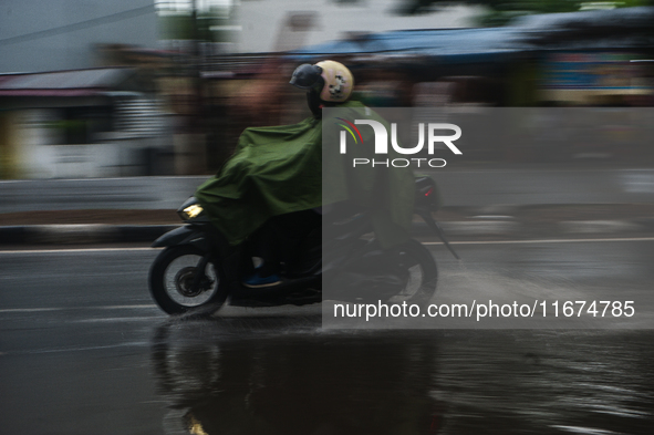 Motorized vehicles pass by Indonesia's Social Security Agency office on the main road of Medan City in North Sumatra, Indonesia, on October...