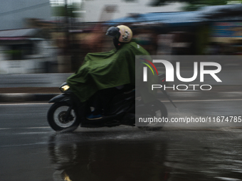 Motorized vehicles pass by Indonesia's Social Security Agency office on the main road of Medan City in North Sumatra, Indonesia, on October...