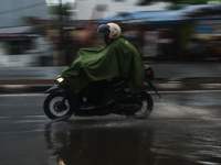 Motorized vehicles pass by Indonesia's Social Security Agency office on the main road of Medan City in North Sumatra, Indonesia, on October...