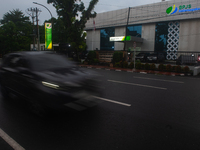 Motorized vehicles pass by Indonesia's Social Security Agency office on the main road of Medan City in North Sumatra, Indonesia, on October...