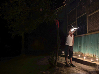 A child plays with light during the 'Deep Utsav or Light festival' before the Diwali festival in Feni, Bangladesh, on October 17, 2024. Diwa...