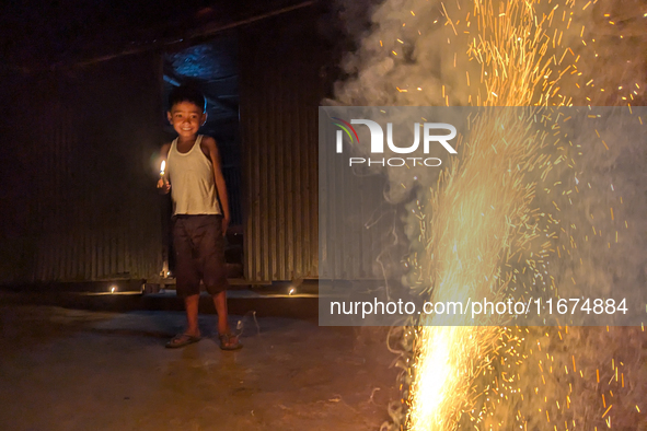 A child plays with light during the 'Deep Utsav or Light festival' before the Diwali festival in Feni, Bangladesh, on October 17, 2024. Diwa...