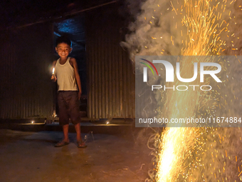 A child plays with light during the 'Deep Utsav or Light festival' before the Diwali festival in Feni, Bangladesh, on October 17, 2024. Diwa...