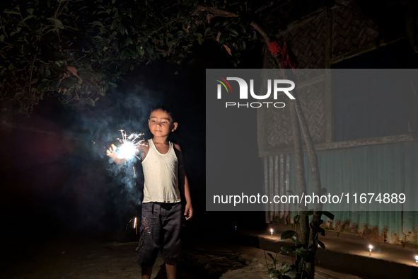 A child plays with light during the 'Deep Utsav or Light festival' before the Diwali festival in Feni, Bangladesh, on October 17, 2024. Diwa...